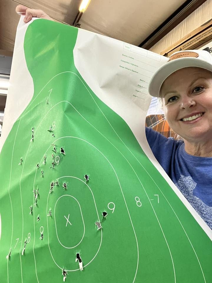 Shooter holding a target after a face to face class at Armed Gun Barn